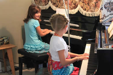 two children at pianos two children at pianos