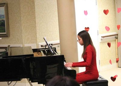 Okan Piano Academy young woman pianist in red dress